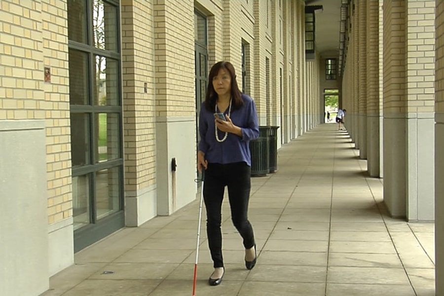 image of Chieko Asakawa walking by the Cohon Center