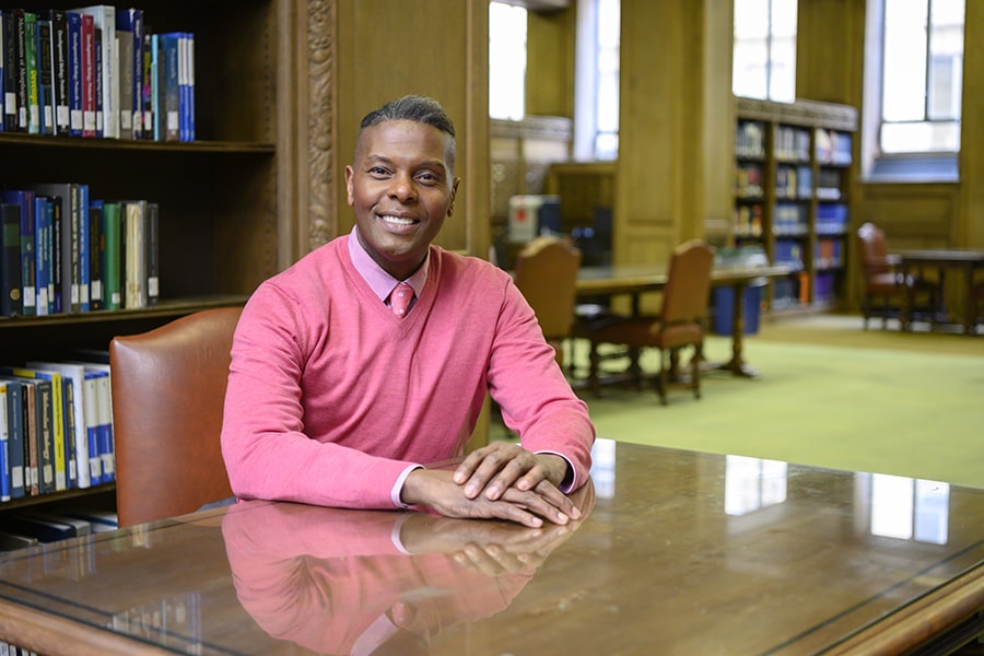 Image of Sebastian Lacy seated at a table in the MCS library