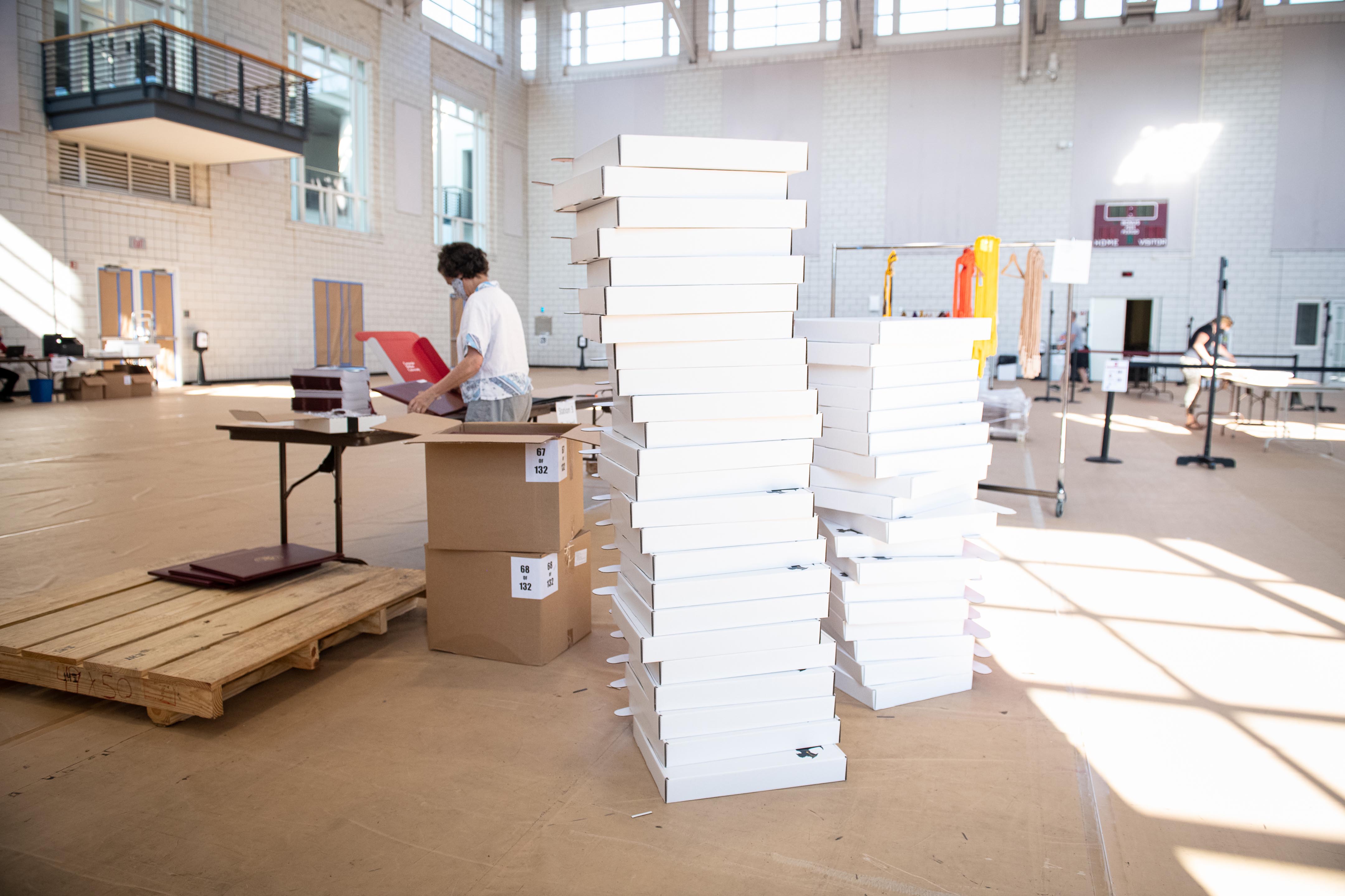 Image of two tall stacks of flat white boxes