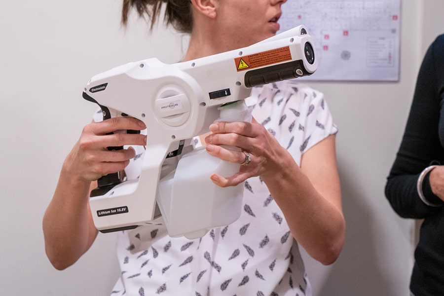 Image of someone holding an electrostatic sprayer