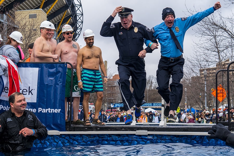 image of CMU police officers Joe Meyers and Jim Moran jumping into a pool at the Polar Plunge