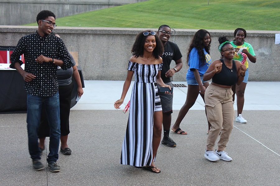image of Lavonca Davis dancing with students on campus