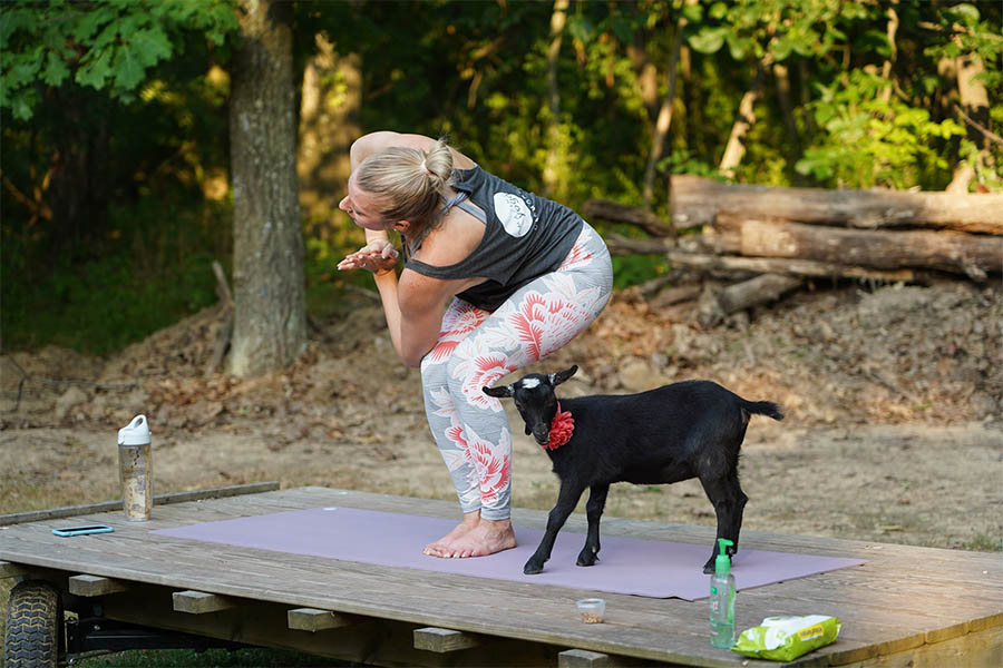 yoga instructor with goat named Piper