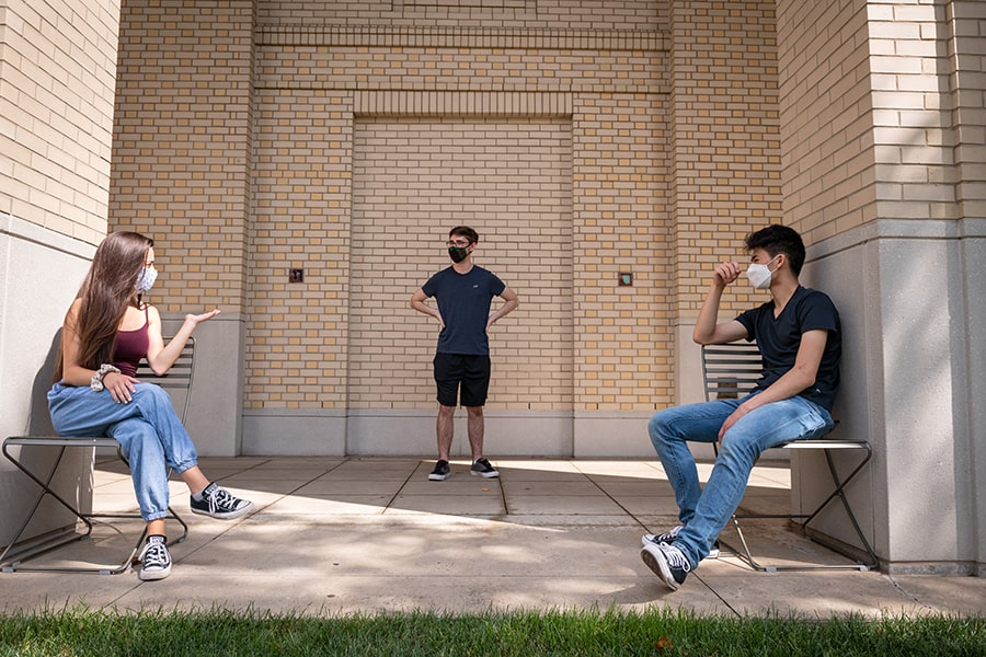 students sitting between the pillars of the Cohon Center loggia