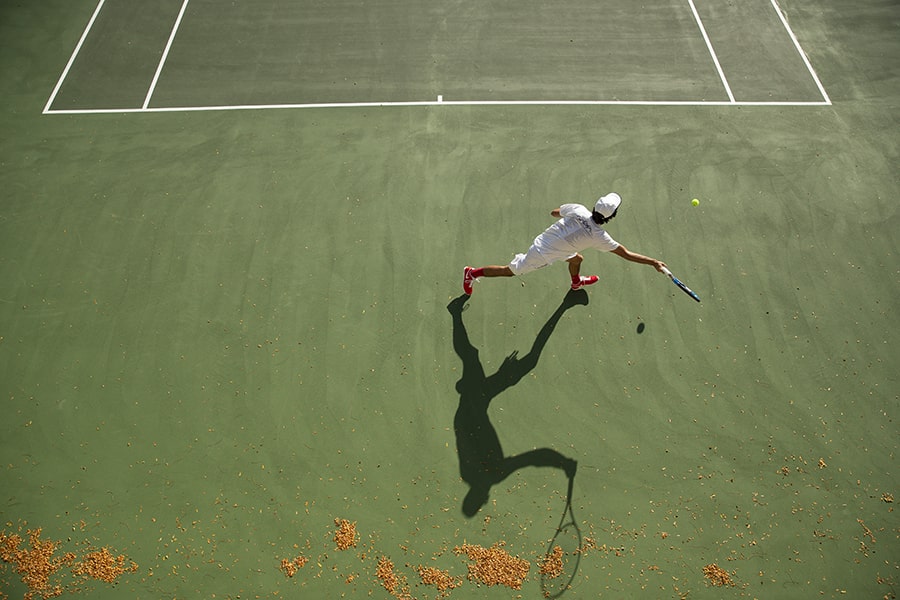 image of a tennis player from above the courts