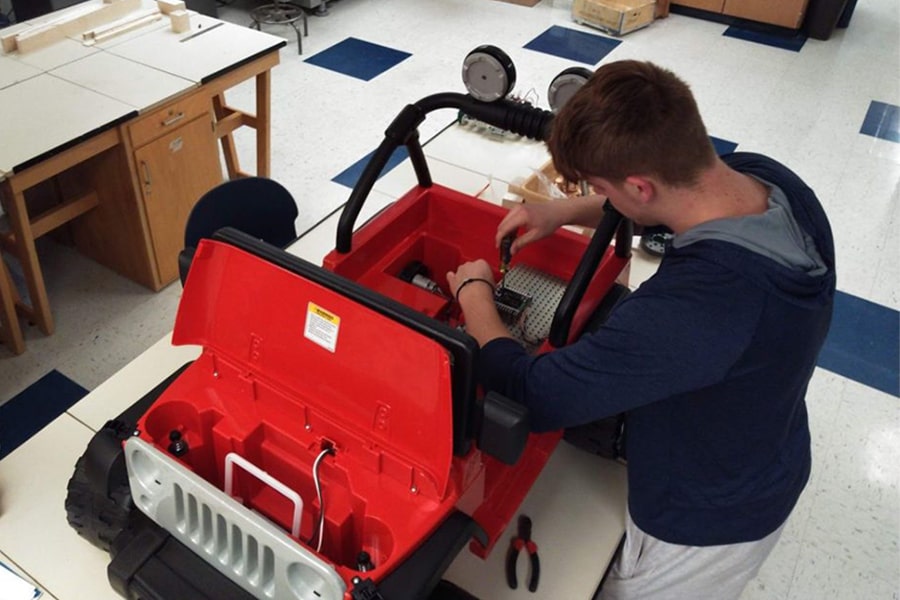 student working on vehicle