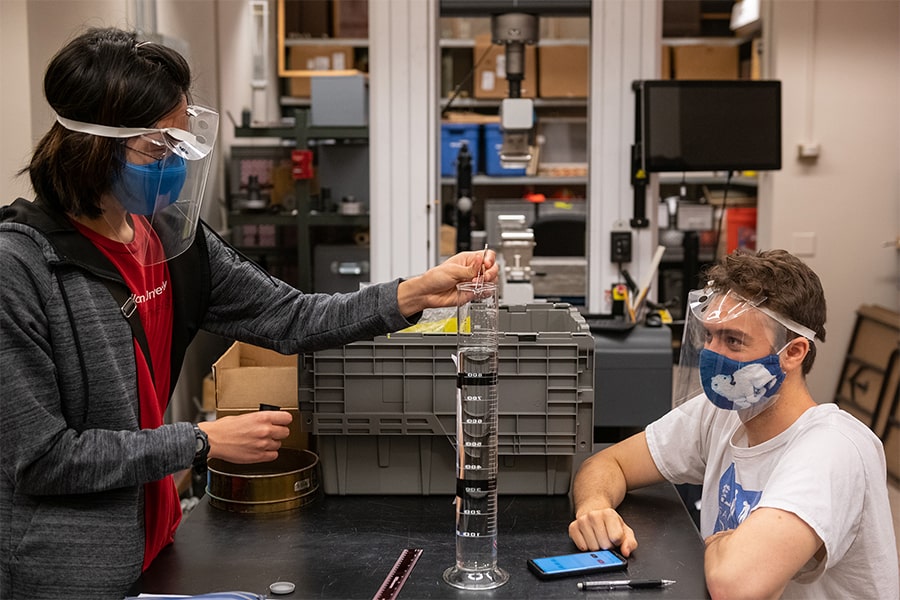 students in lab wearing masks and face shields