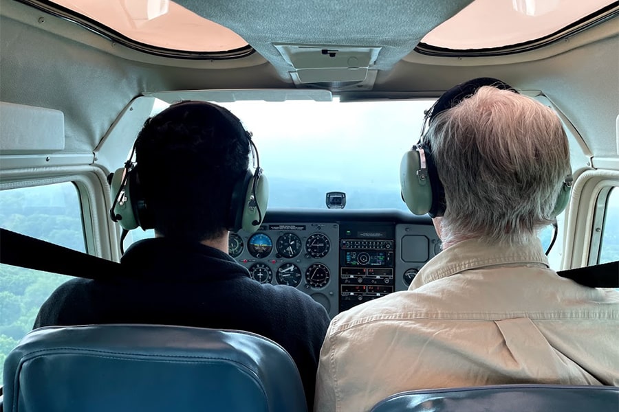 view from backseat of plane of pilot and instructor