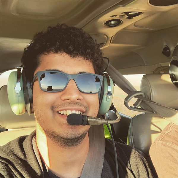 image of Jay Patrikar smiling in cockpit wearing headset