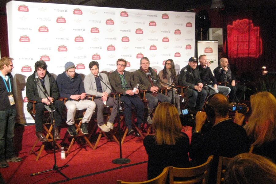 actors and producers of Margin Call movie seated side by side on a stage