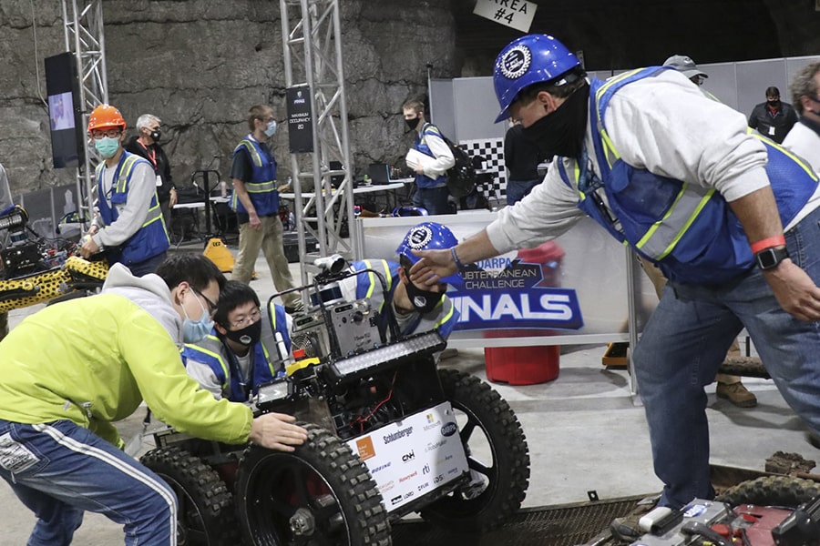 Team Explorer works on one of its robots