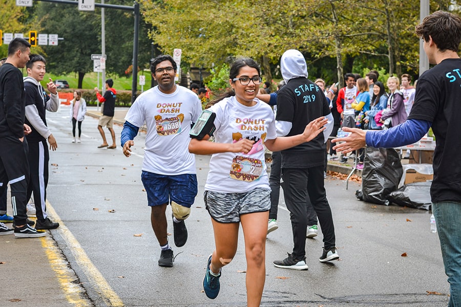 a student crosses the finish line at the 2019 Donut Dash
