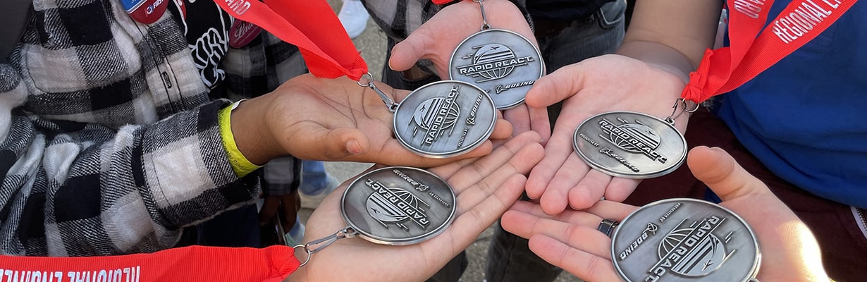 a closeup of the medals won by the Girls of Steel