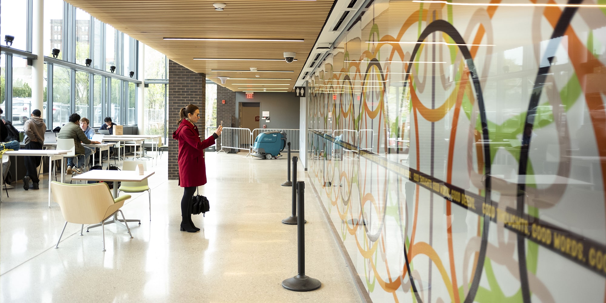 a person looks at the mural in TCS Hall