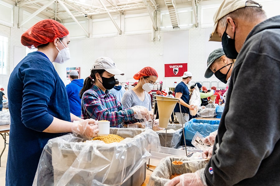 CMU volunteers packing meals in an assembly line for Rise Agains Hunger