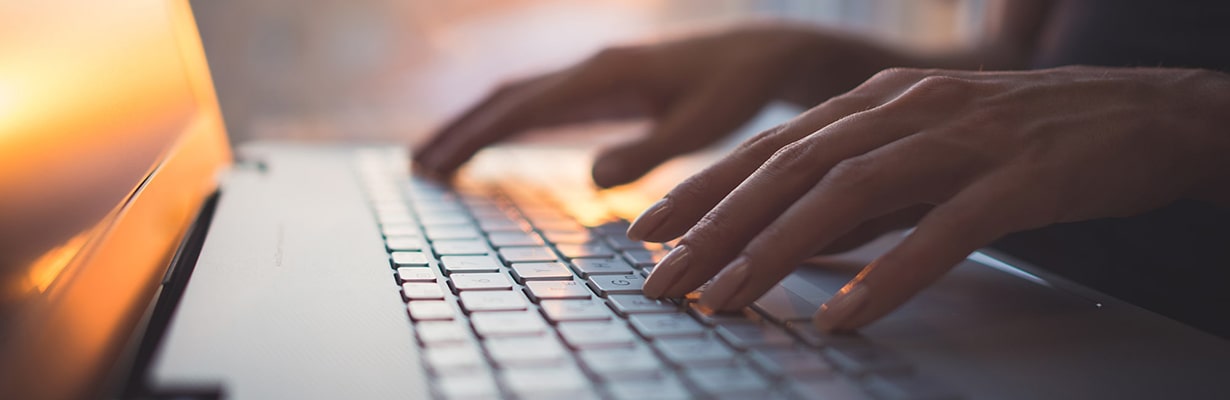 hands on a laptop keyboard