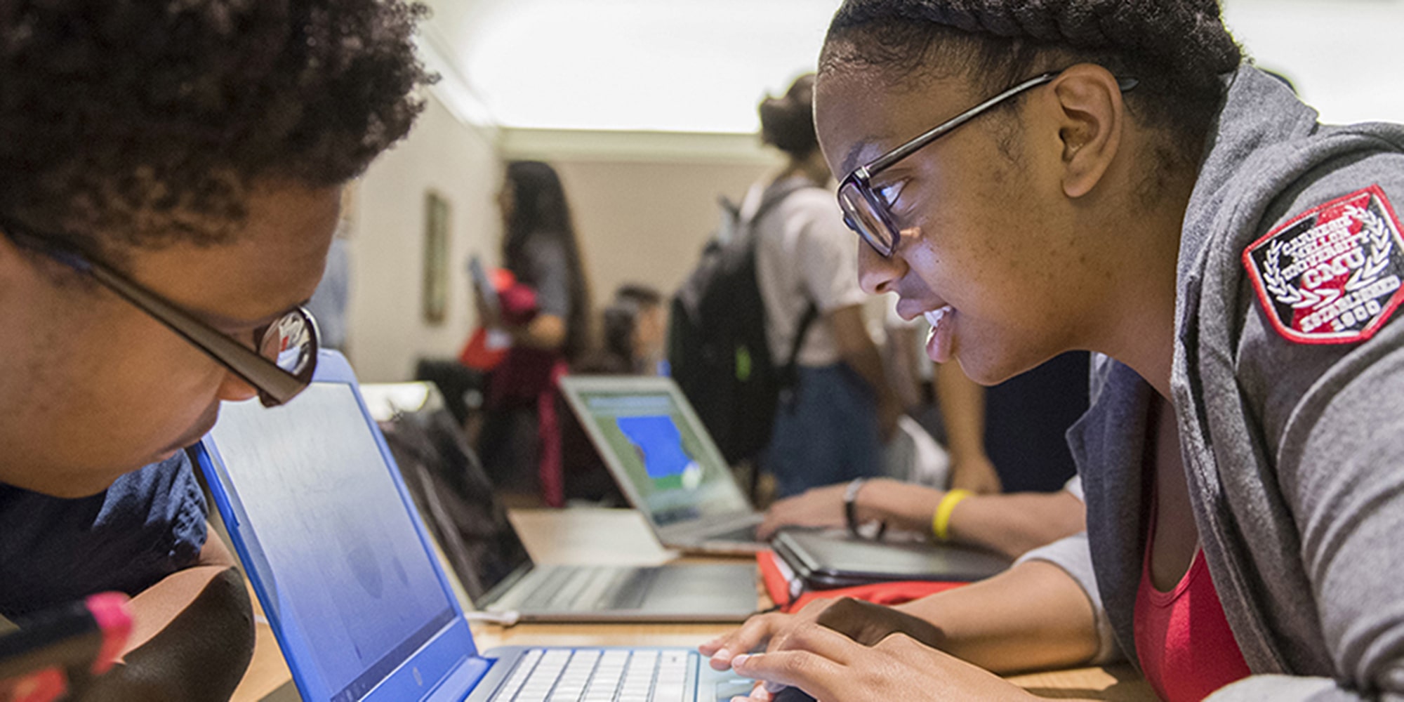 a student is focused on her laptop screen