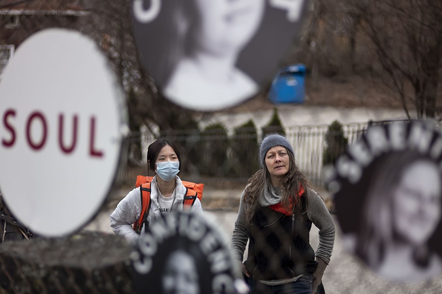 Ruiqi (Elmy) Chen and photographer Heather Mull at Mull's outdoor exhibit in Hazelwood