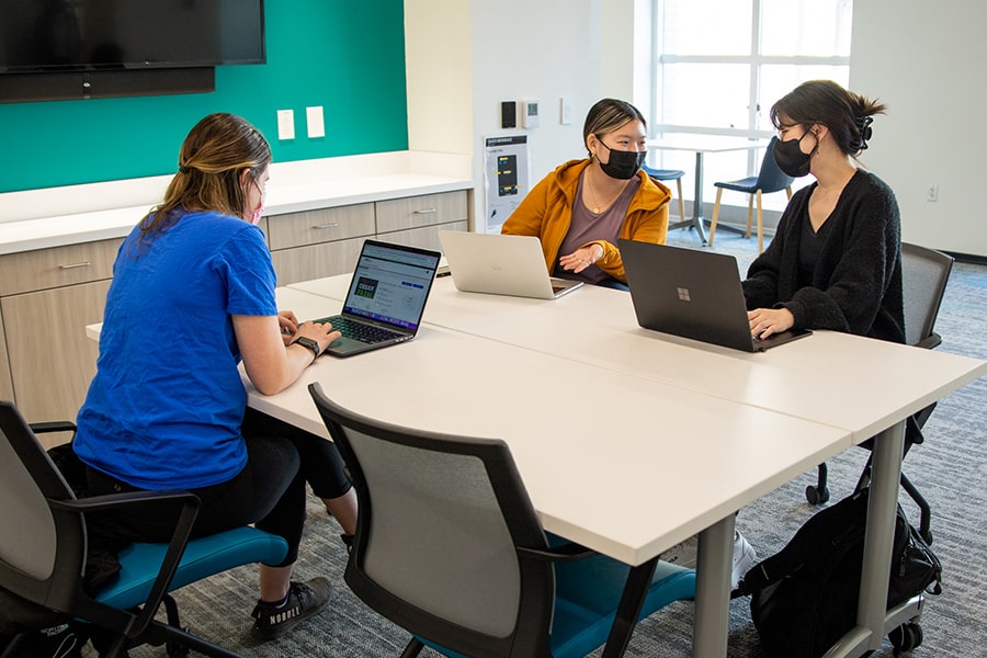 students work at a table in the new Nexus for Civic Engagement