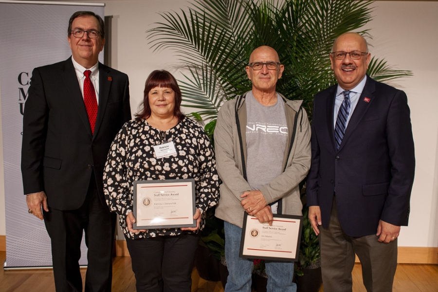 45-year staff members Patti Steranchak and James Martin pose with Matt D'Emilio and President Jahanian