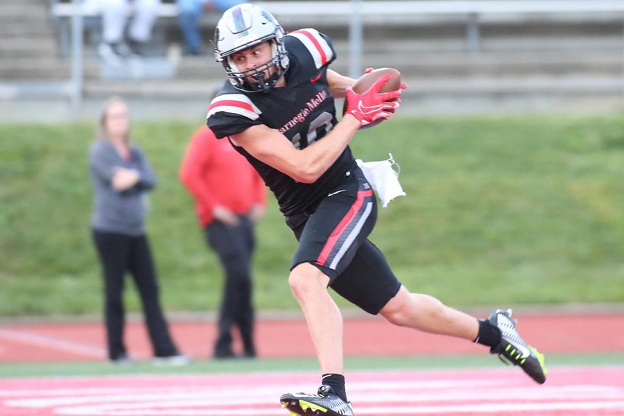 Kris Hughes runs with the football in game action