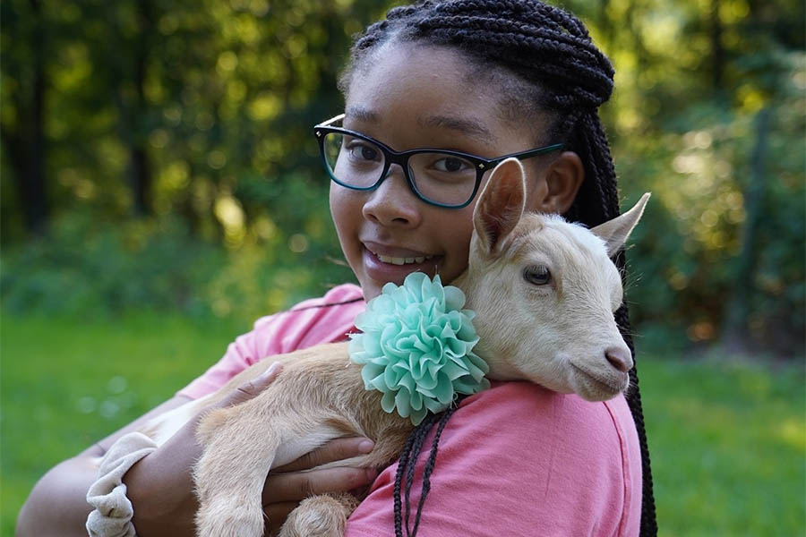 girl holding goat