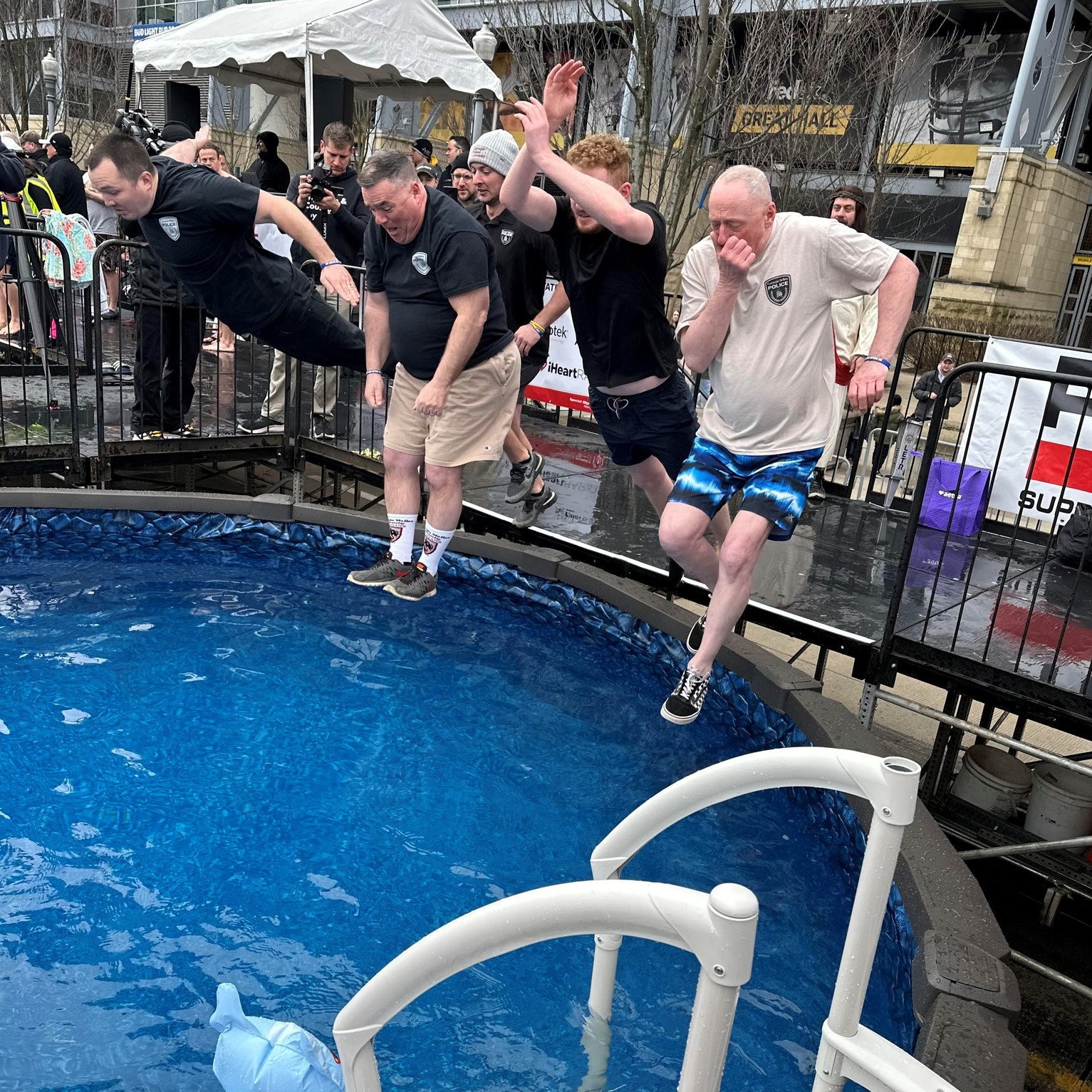 Officers jumping into pool for polar plunge