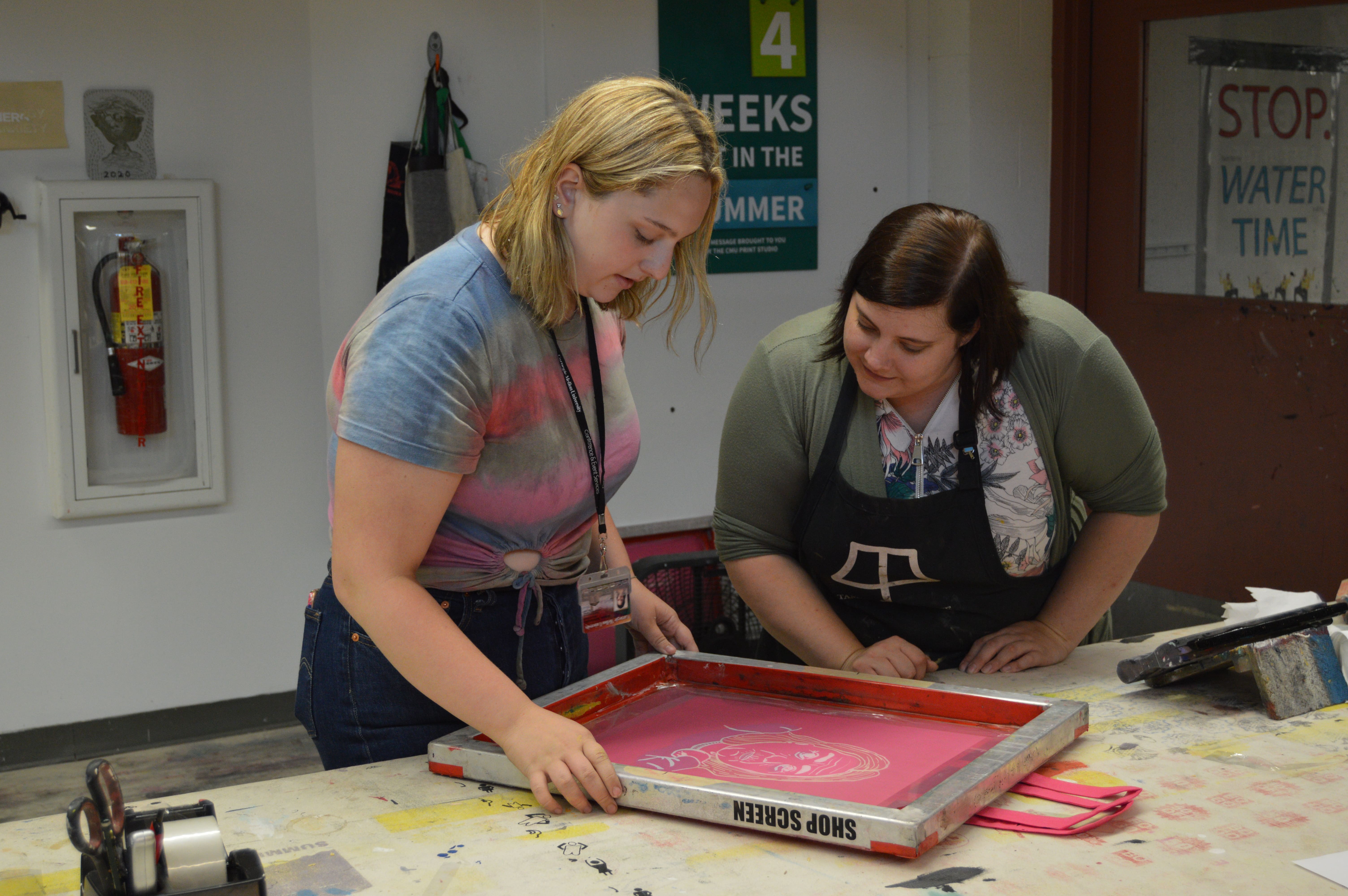 Student and teacher working on screen printing in an art studio