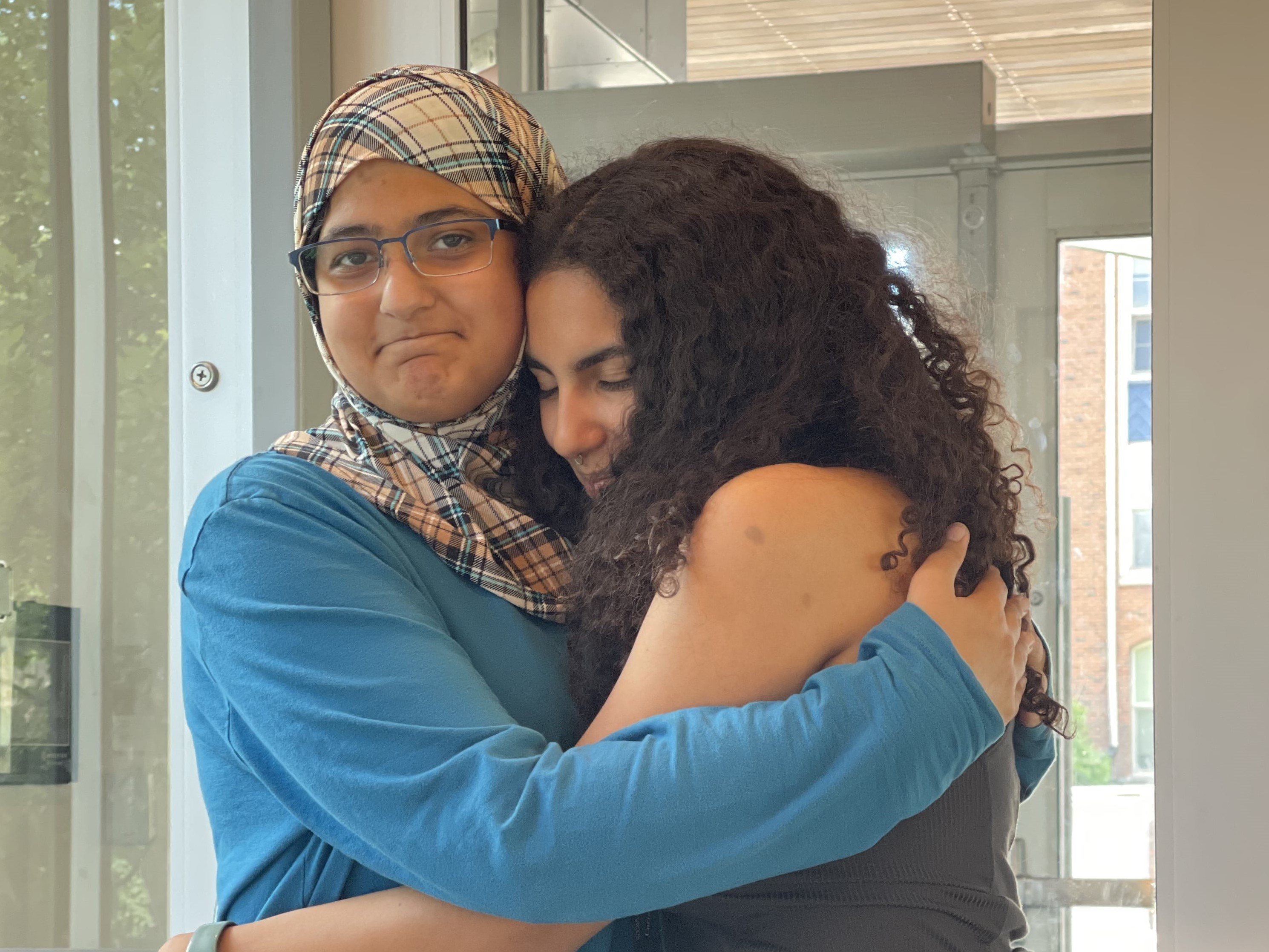 Pre-College RA and student hugging goodbye on the final day. 