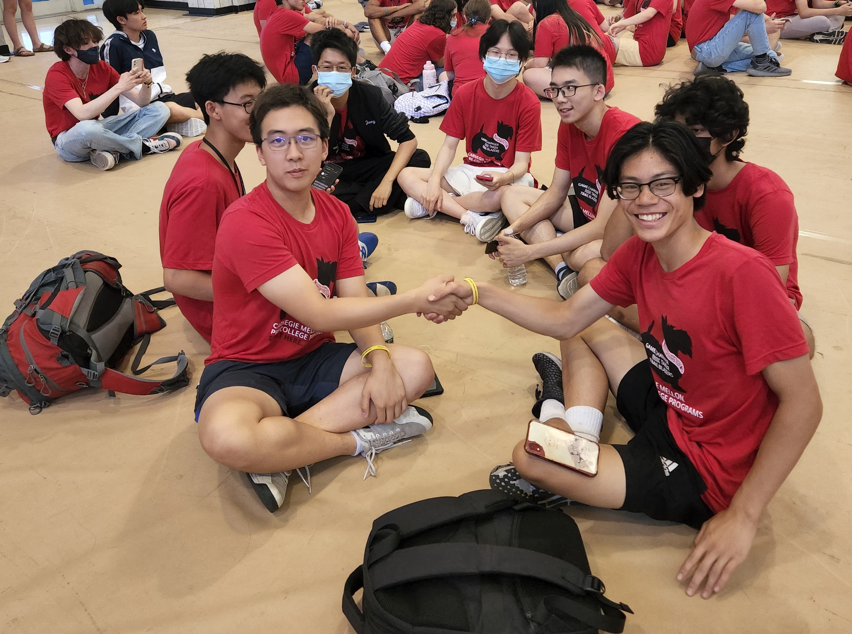 Pre-College students shaking hands during the Playfest. 