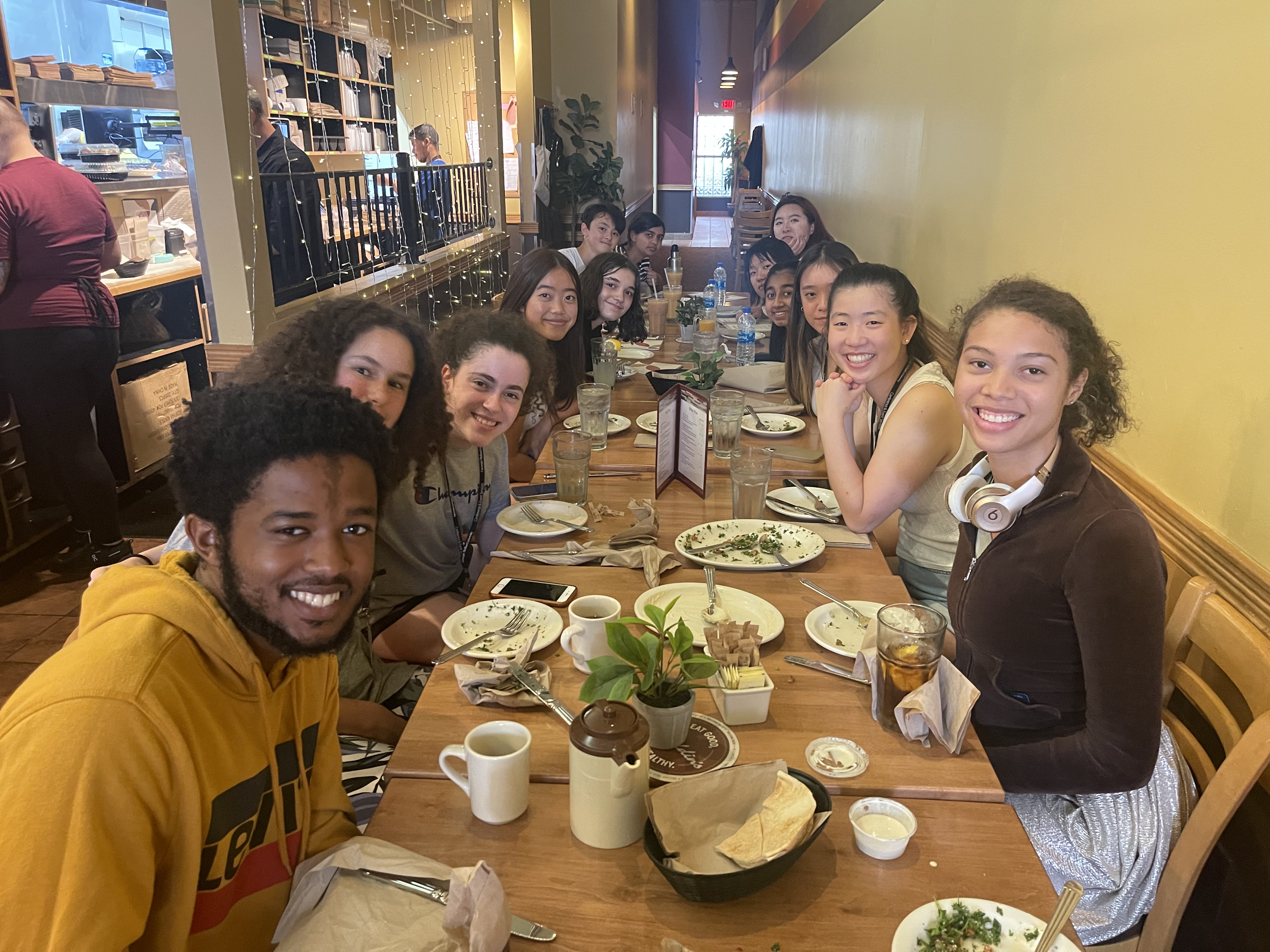 Pre-College students and RAs having dinner in a restaurant.