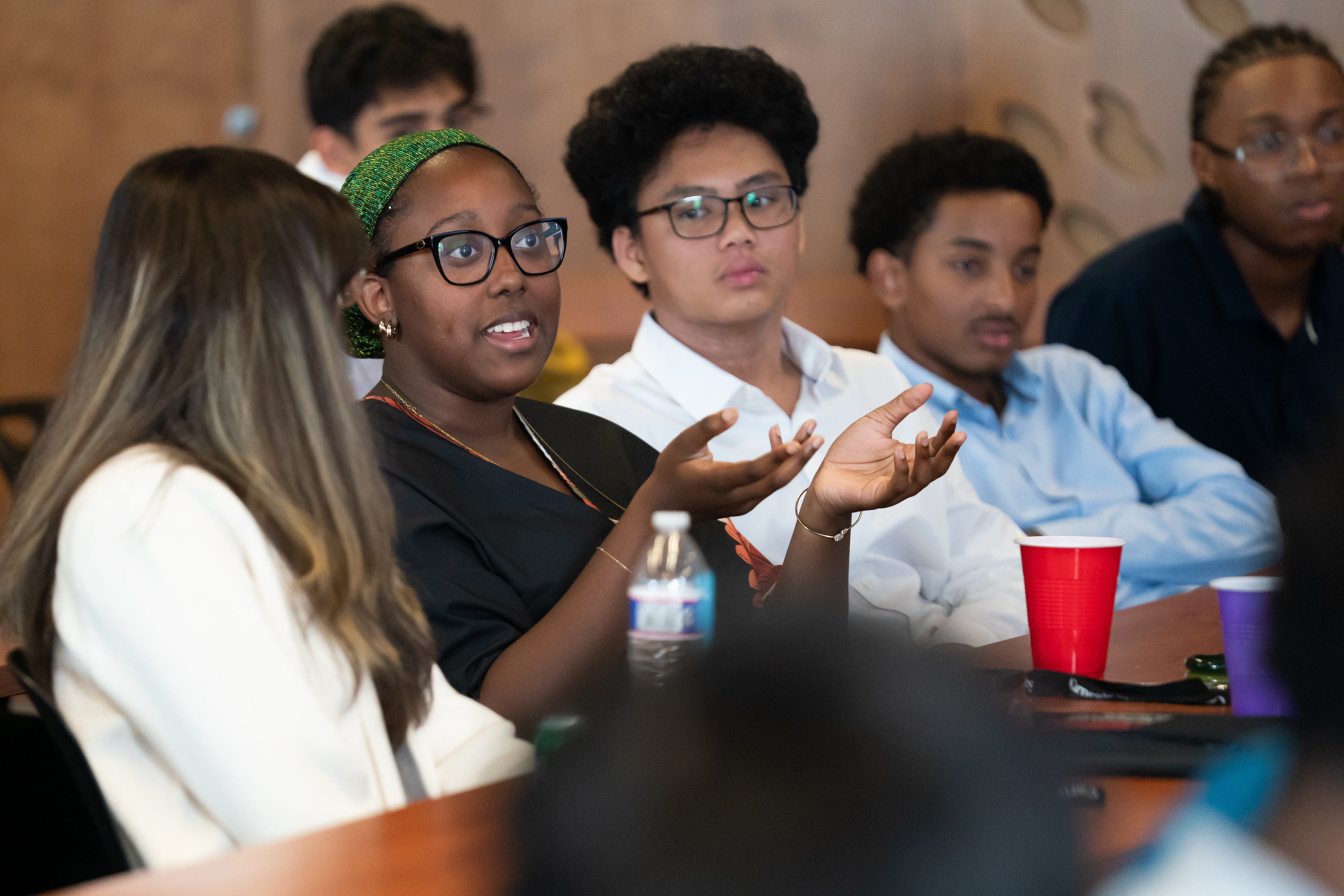Students asking questions during final Symposium