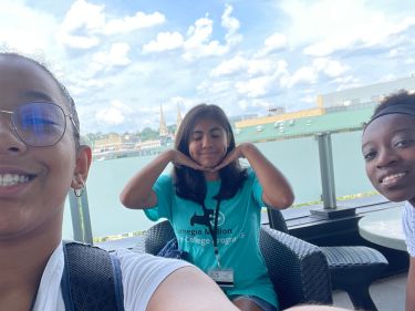 Pre-College students with a panoramic view of one of Pittsburgh's rivers behind them.