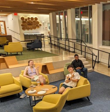 Student photo of club meeting in dorm lobby.