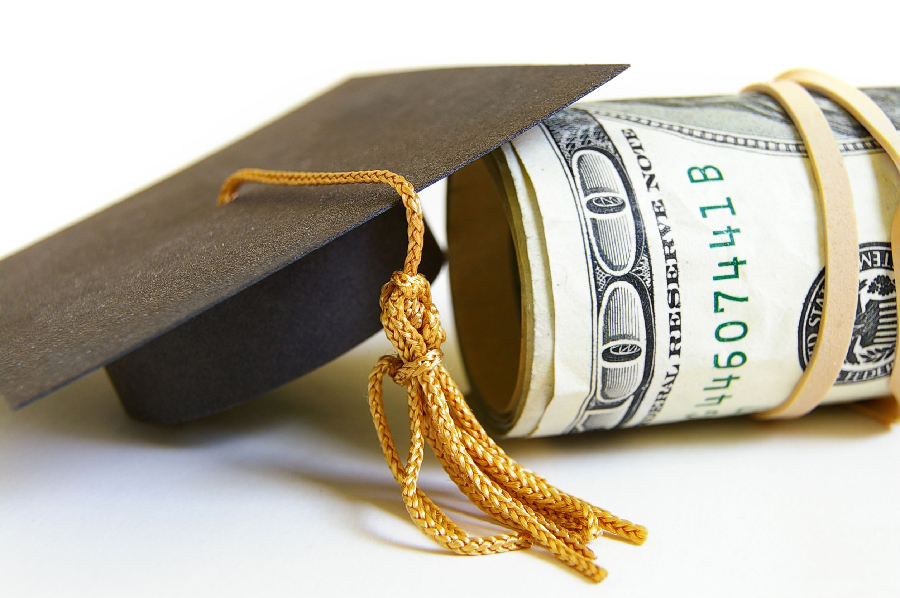 Graduation cap with rolls of money