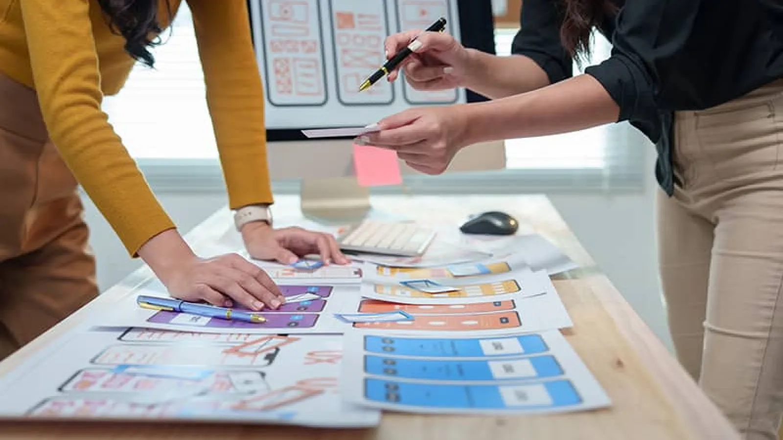 Two Carnegie Mellon UI/UX designers discussing mobile layouts
