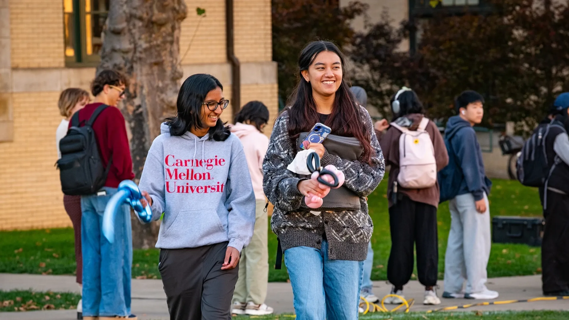 Two students walking across campus