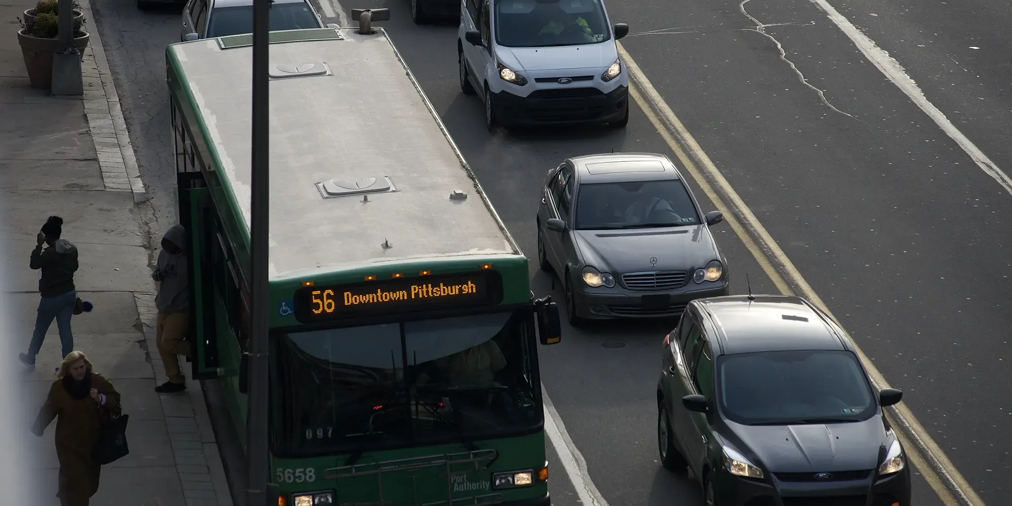 a bus and cars on a Pittsburgh road