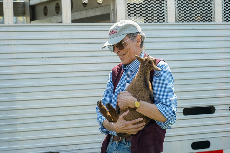 Walker holds a baby goat