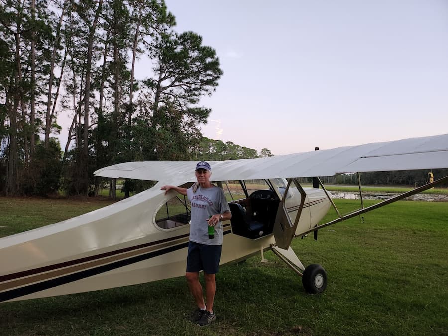 Janet Marnane standing next to a single engine airplane