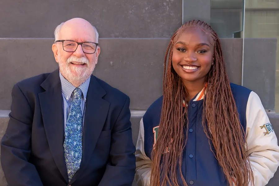 Thomas Ferguson standing with a student