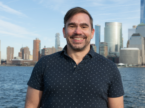 Cameron Brown in front of the NYC skyline