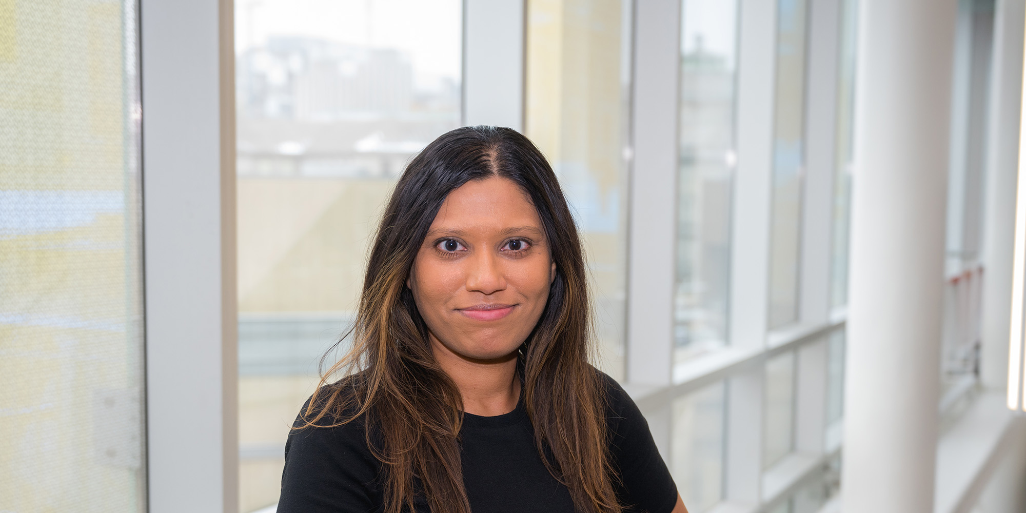Valentina Dutta, an Indian woman with brown hair, smiles into the camera.