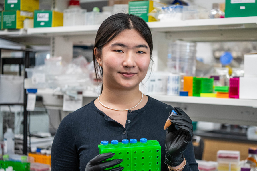 Woman posing in a chemistry lab.