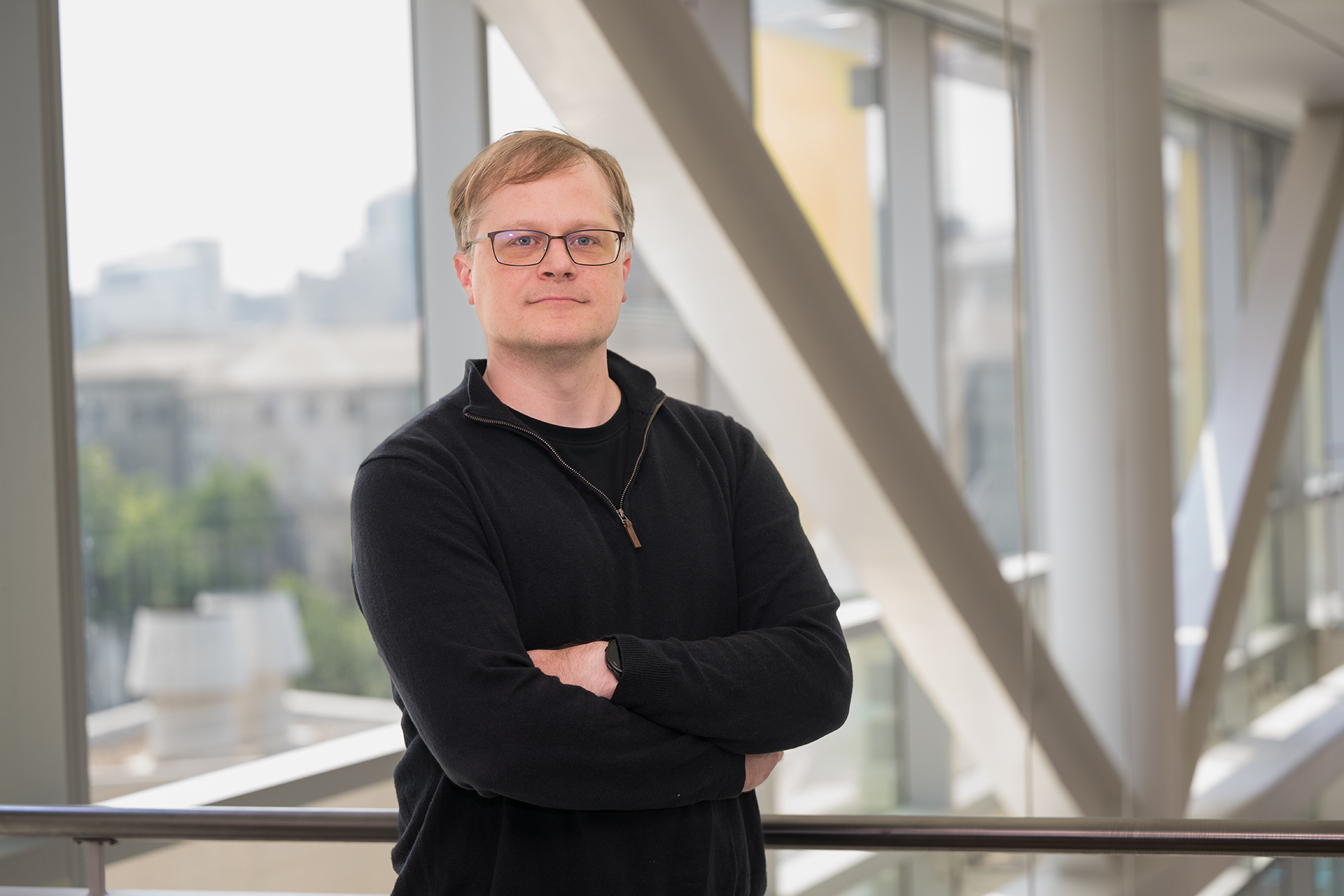 Image of a man standing with his arms crossed.