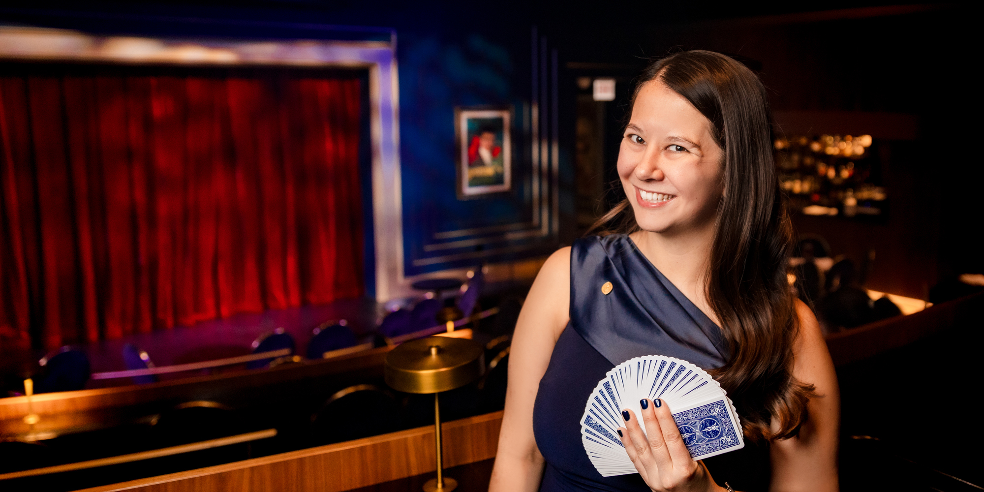 Tori Noquez holds up playing cards in hand