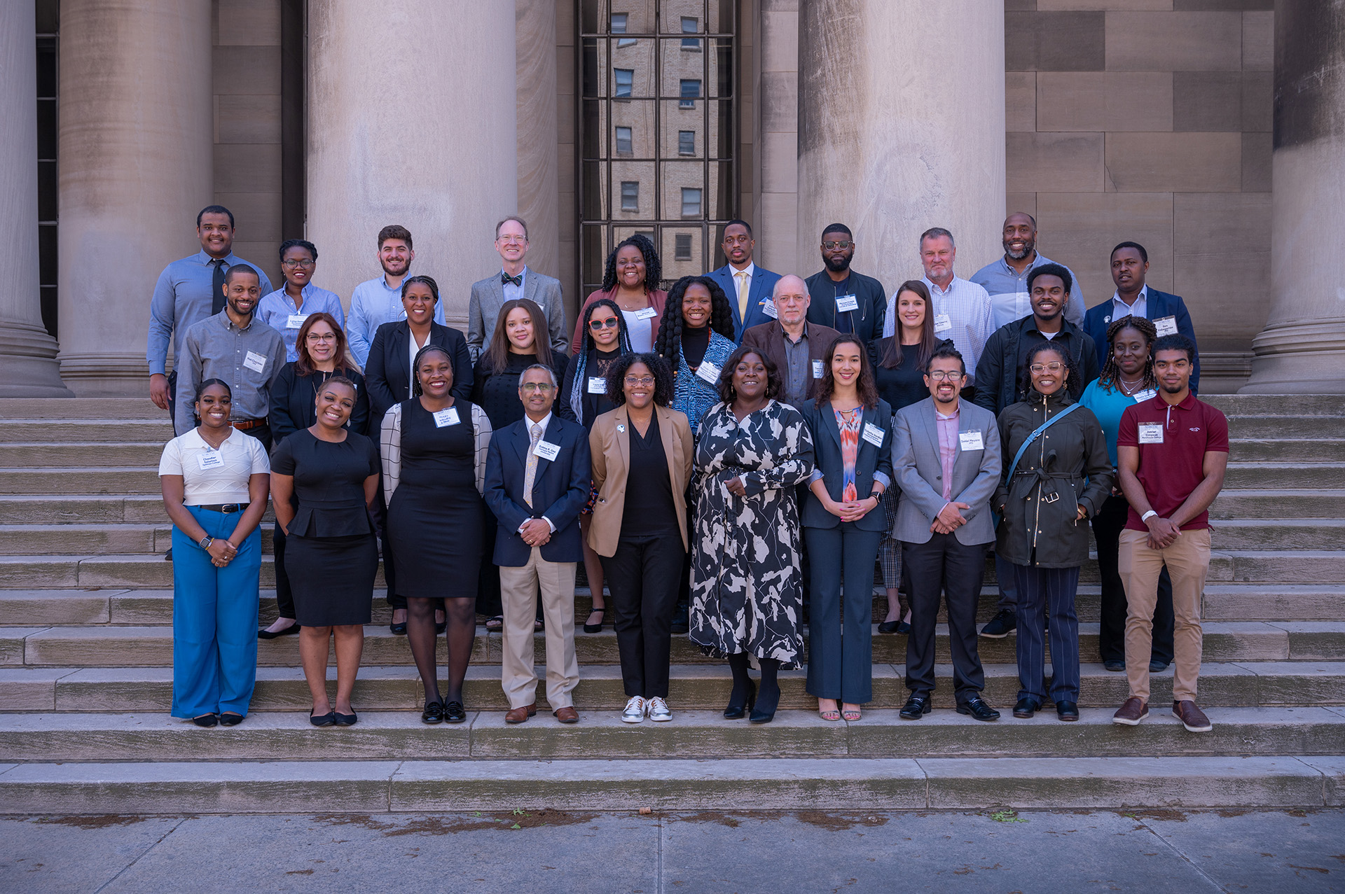 A group of people stand outside of Mellon Institute.