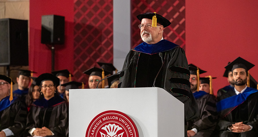 Michael Trick stands at a podium.