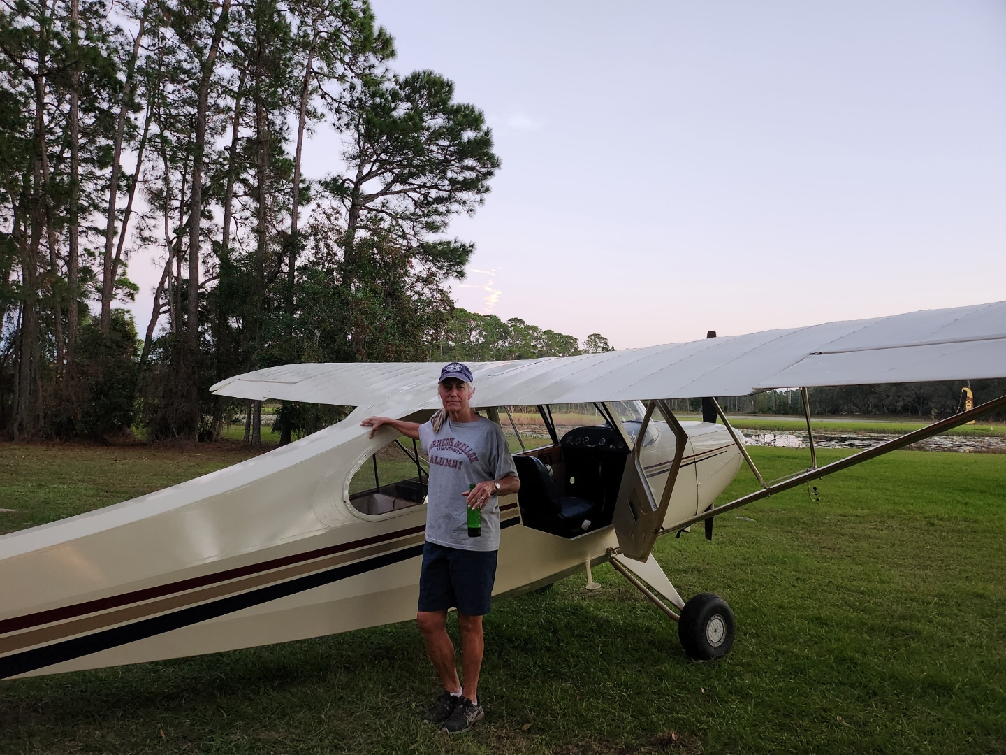 Janet Marnane stands with a plane and smiles at the camera.