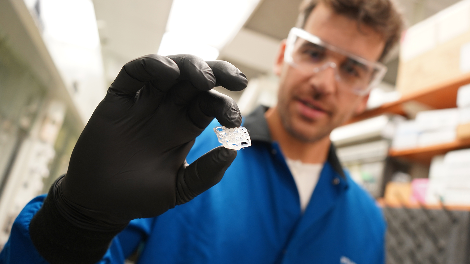 Frank Leibfarth from UNC Chapel Hill squishes a 3D printed cube made out of a new polymer.